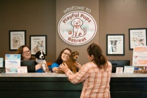 puppy checking in for puppy boarding with staff